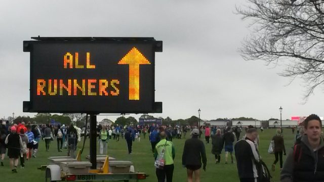 A large electronic sign saying 'All Runners' - directing runners on Blackheath