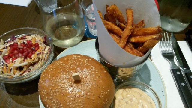 A meal the day after - vegie burger, sweet potato fries with mayo, coleslaw and a glass of wine.