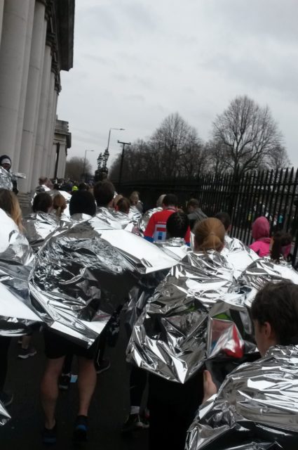 Crowds of runners ahead with foil blankets