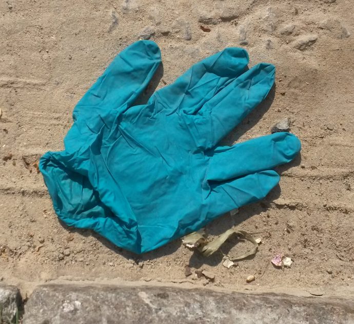 Blue glove discarded in the street