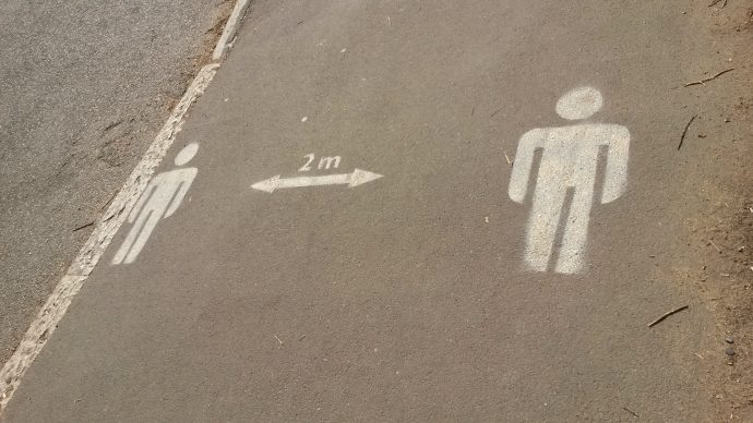 2m social distancing sign on footpath