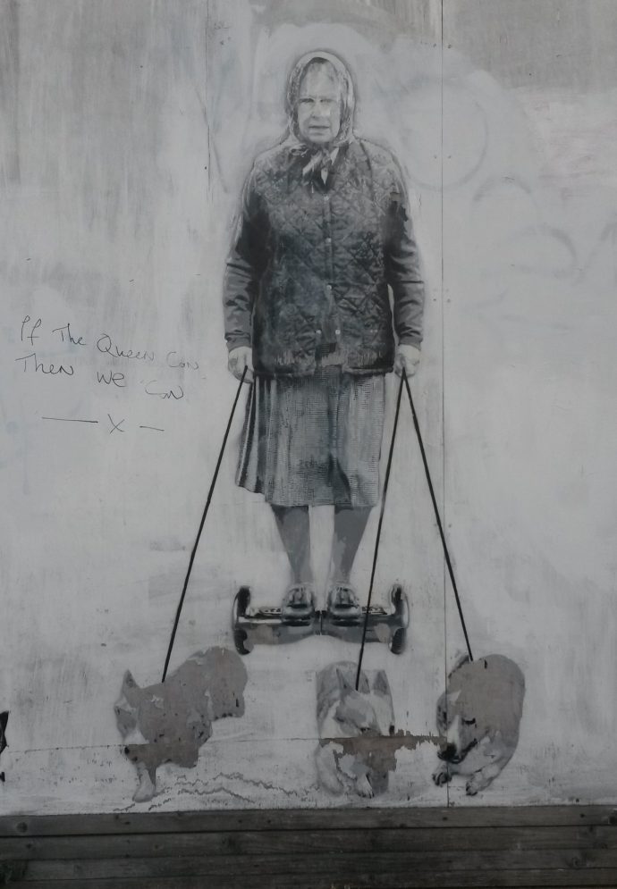 Graffiti image of Queen on hoverboard being led by 3 corgees