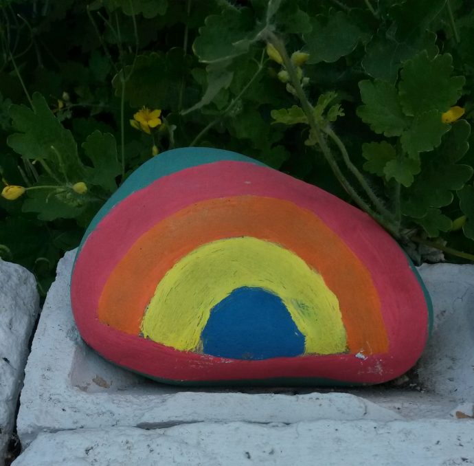 Rock painted in rainbow colours