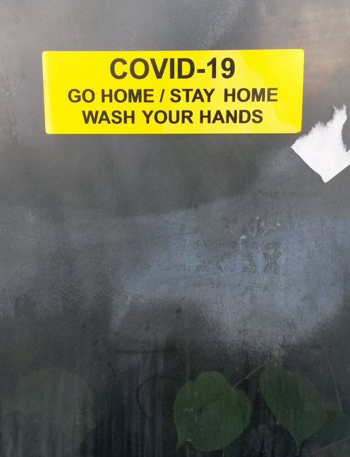 Day 75 of lockdown, sticker in bus shelter with Covid-19- go home, stay home, wash your hands